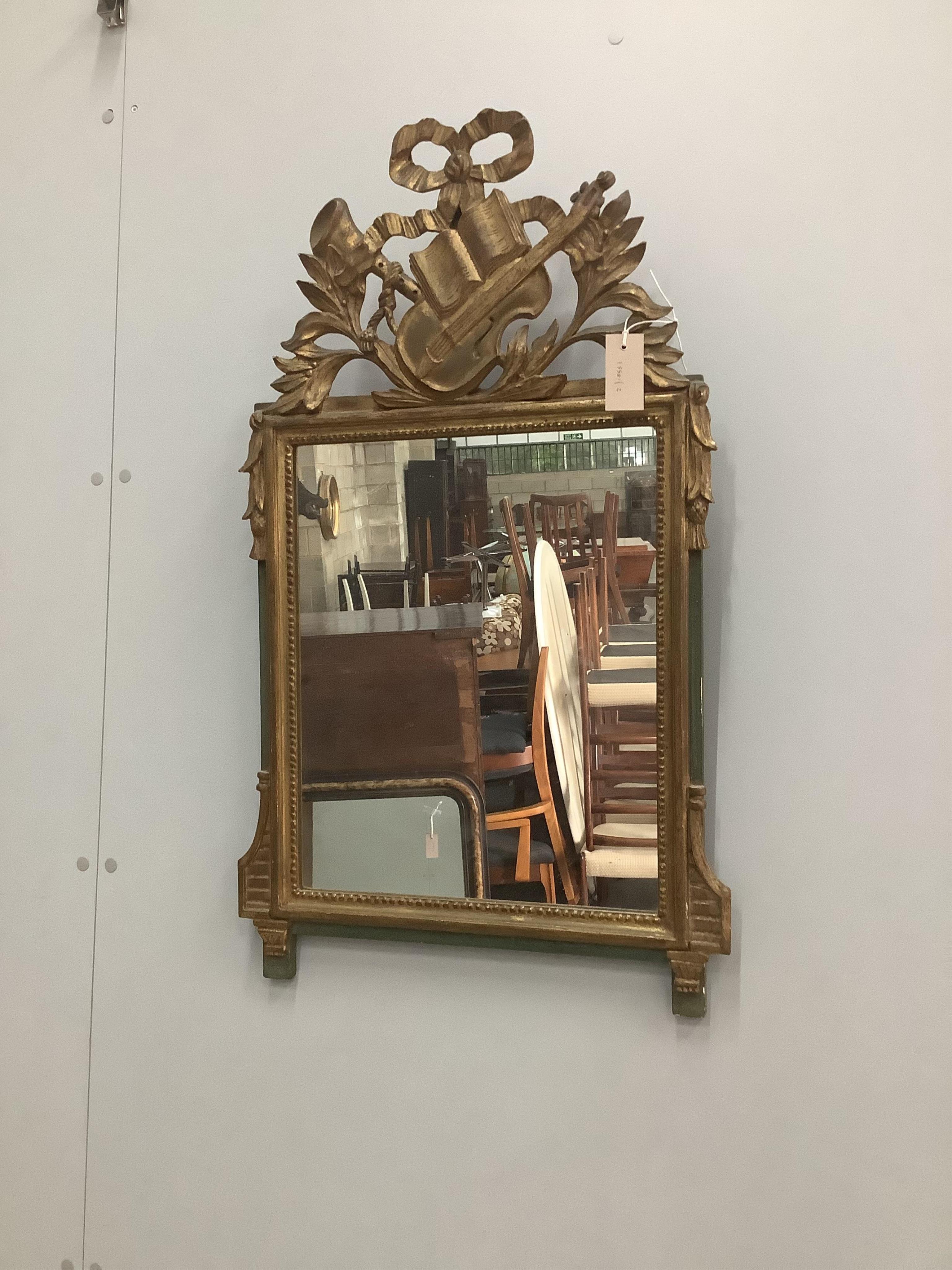 A carved giltwood wall mirror, width 50cm, height 84cm. Condition - fair